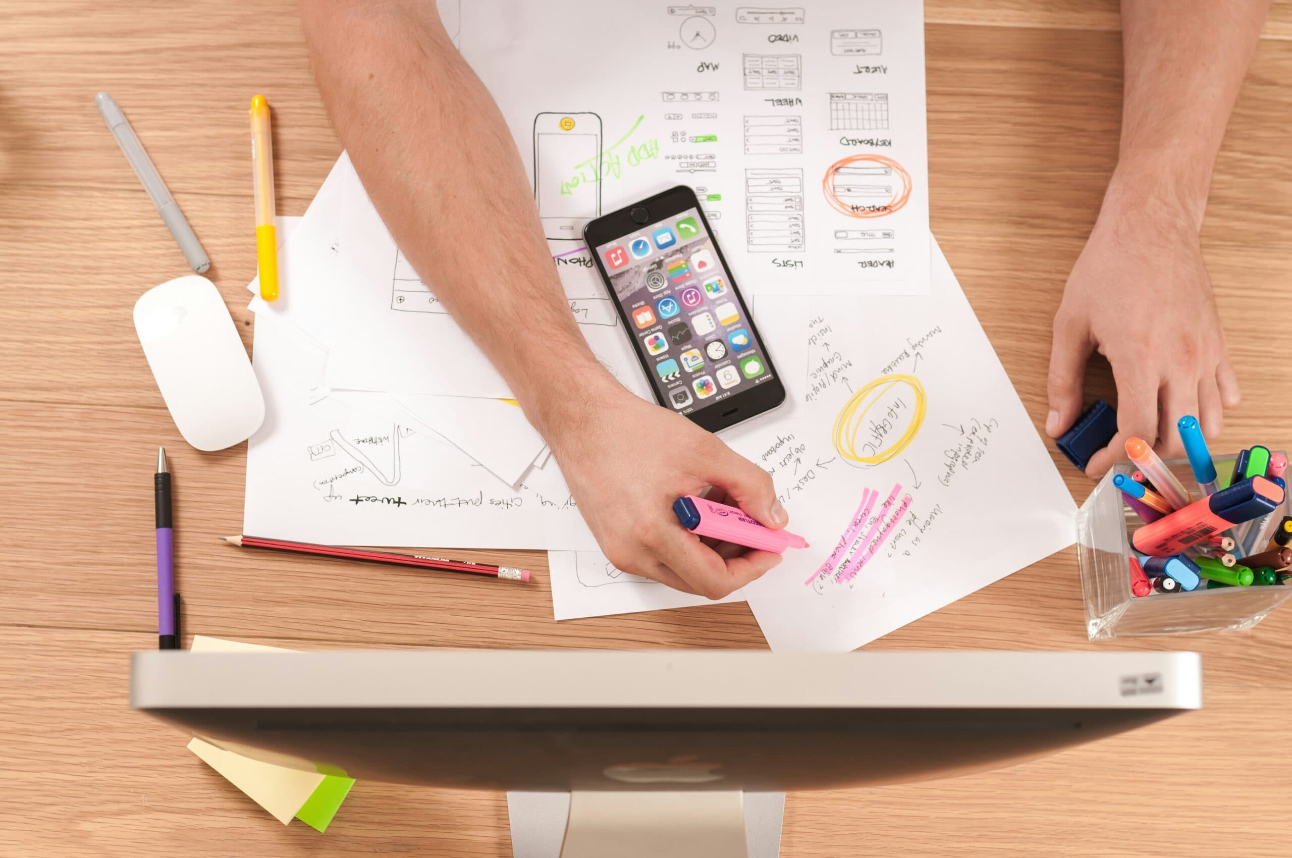 phone on top of papers on a desk