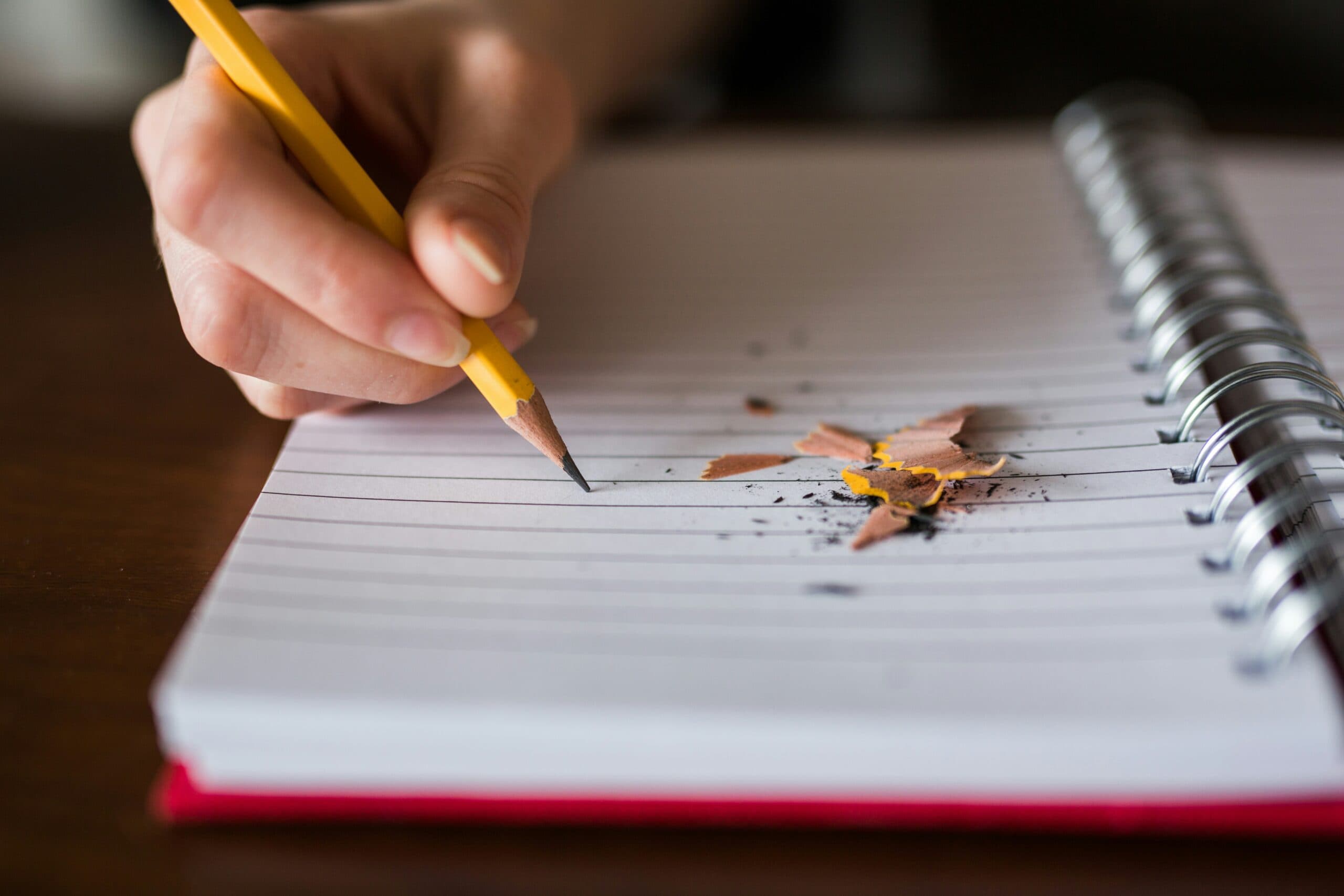 person writing on a notebook