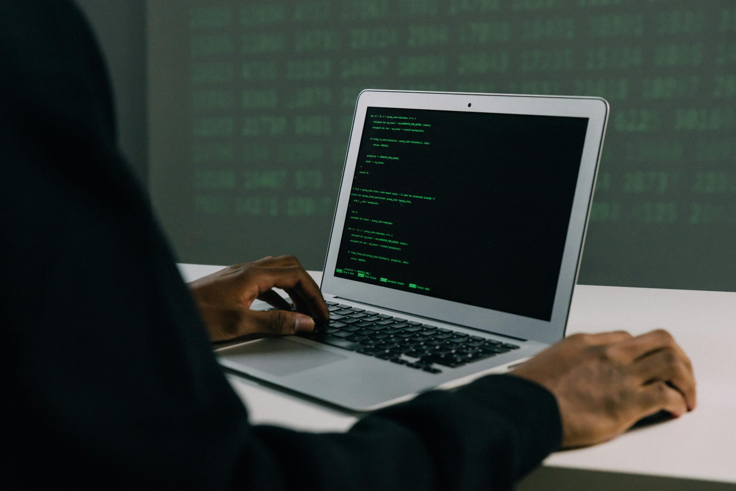 man coding on his laptop