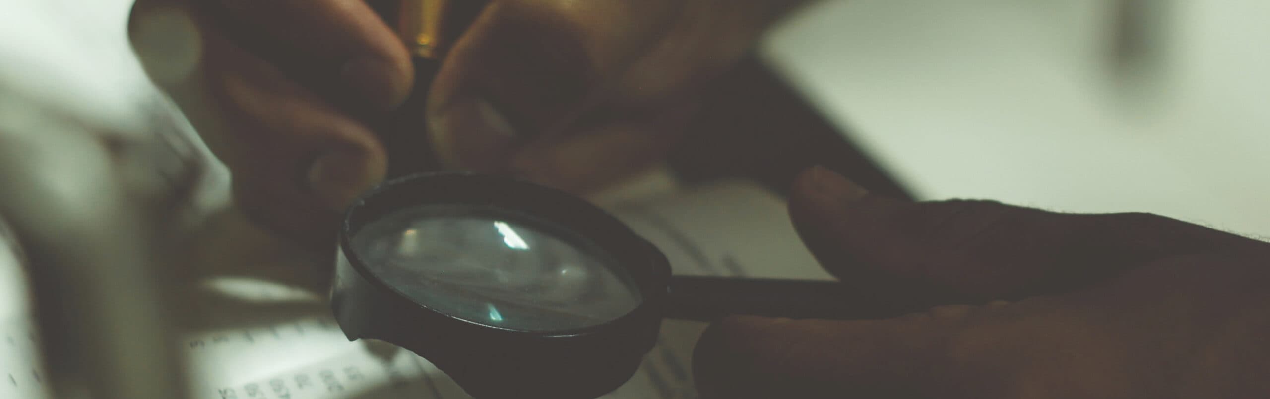Person using magnifying glass