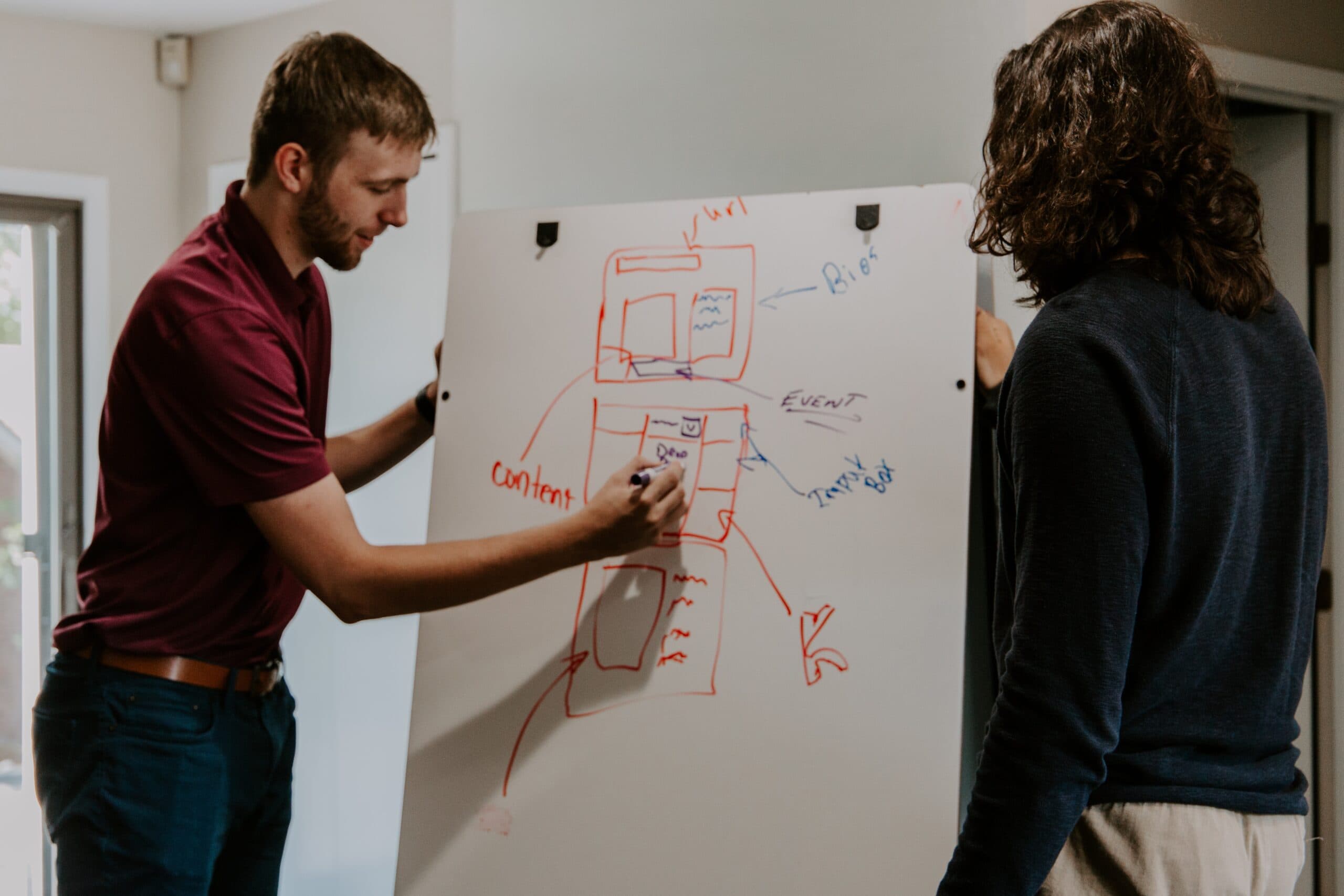 man writing on a whiteboard