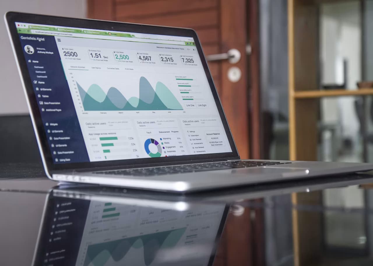 Laptop screen showing a statistics dashboard on a desk