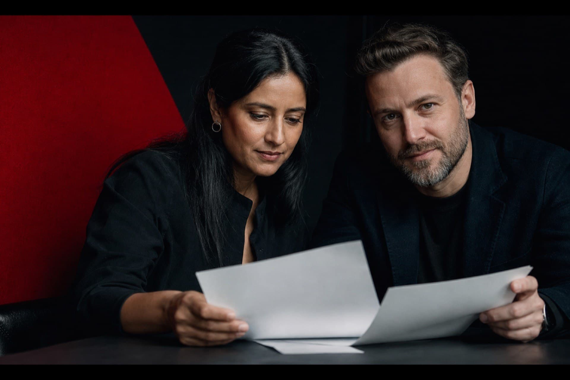A business owner and senior advisor reviewing marketing strategy together in a meeting room