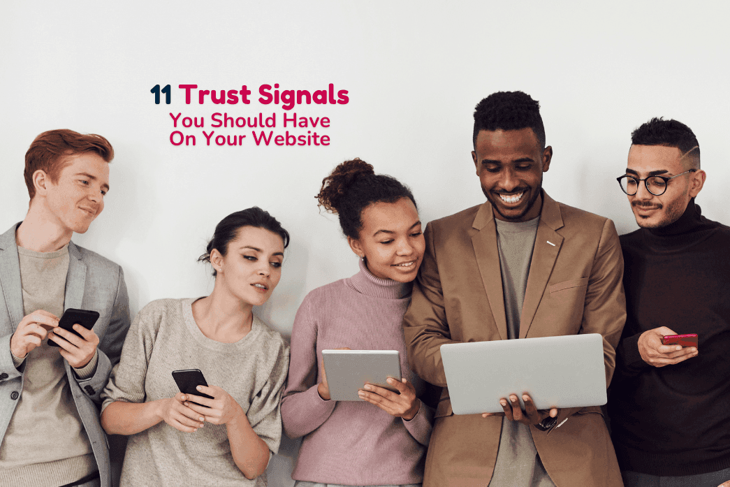 A group of people in casual clothing look at a website on various devices.