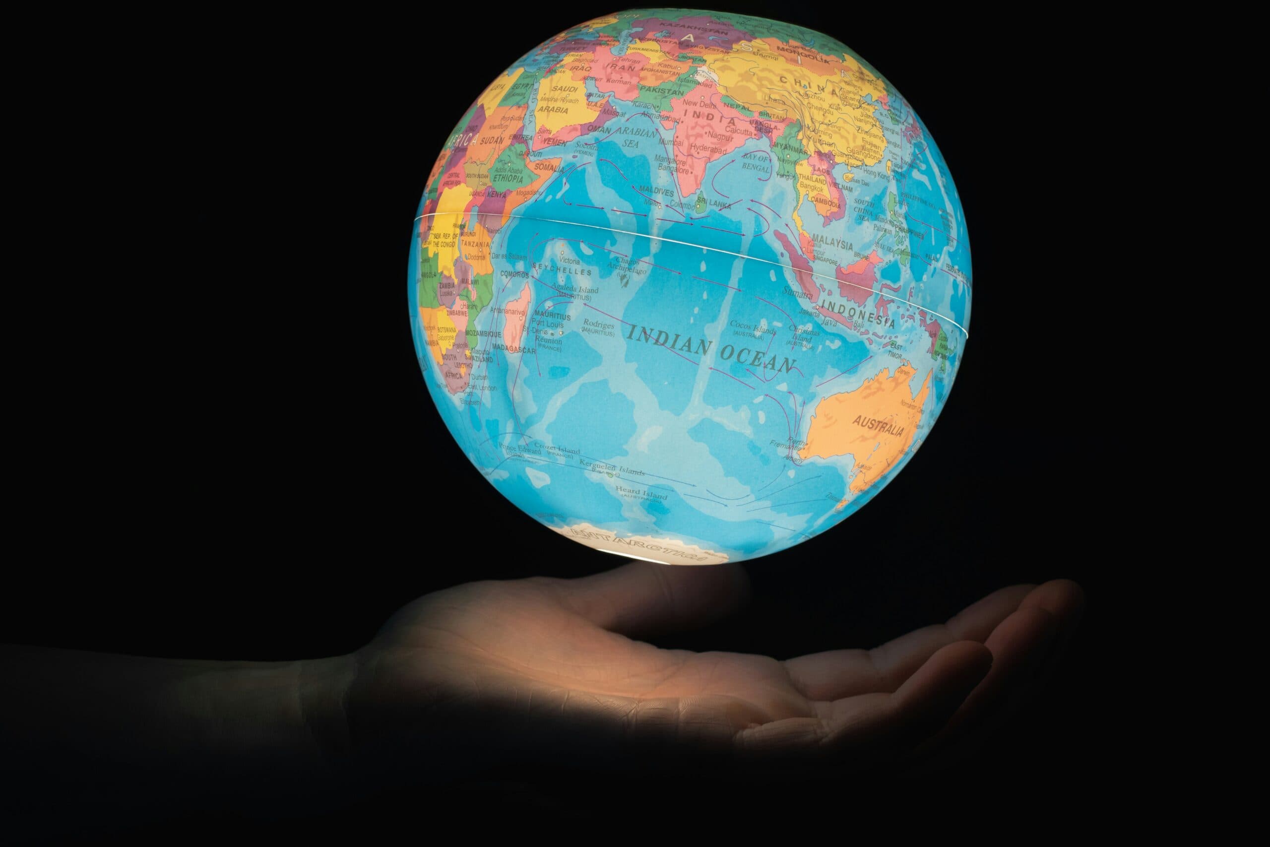 a globe floating over a hand