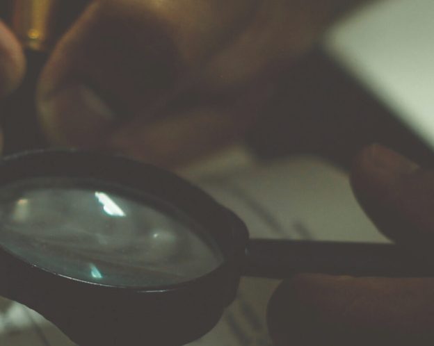 Person using magnifying glass