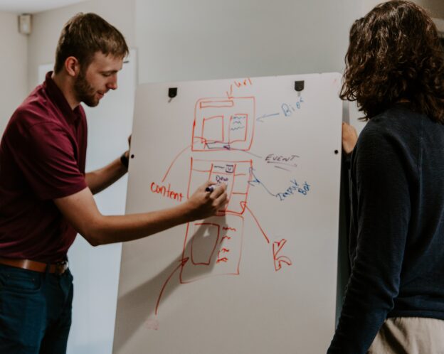 man writing on a whiteboard